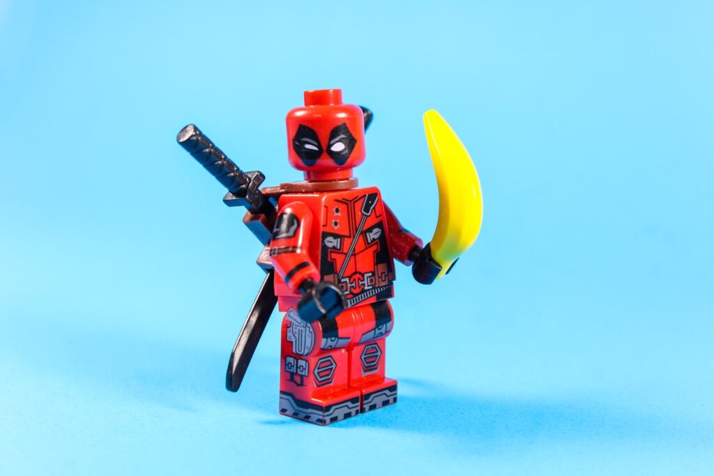 Lego deadpool holding a banana with a sword